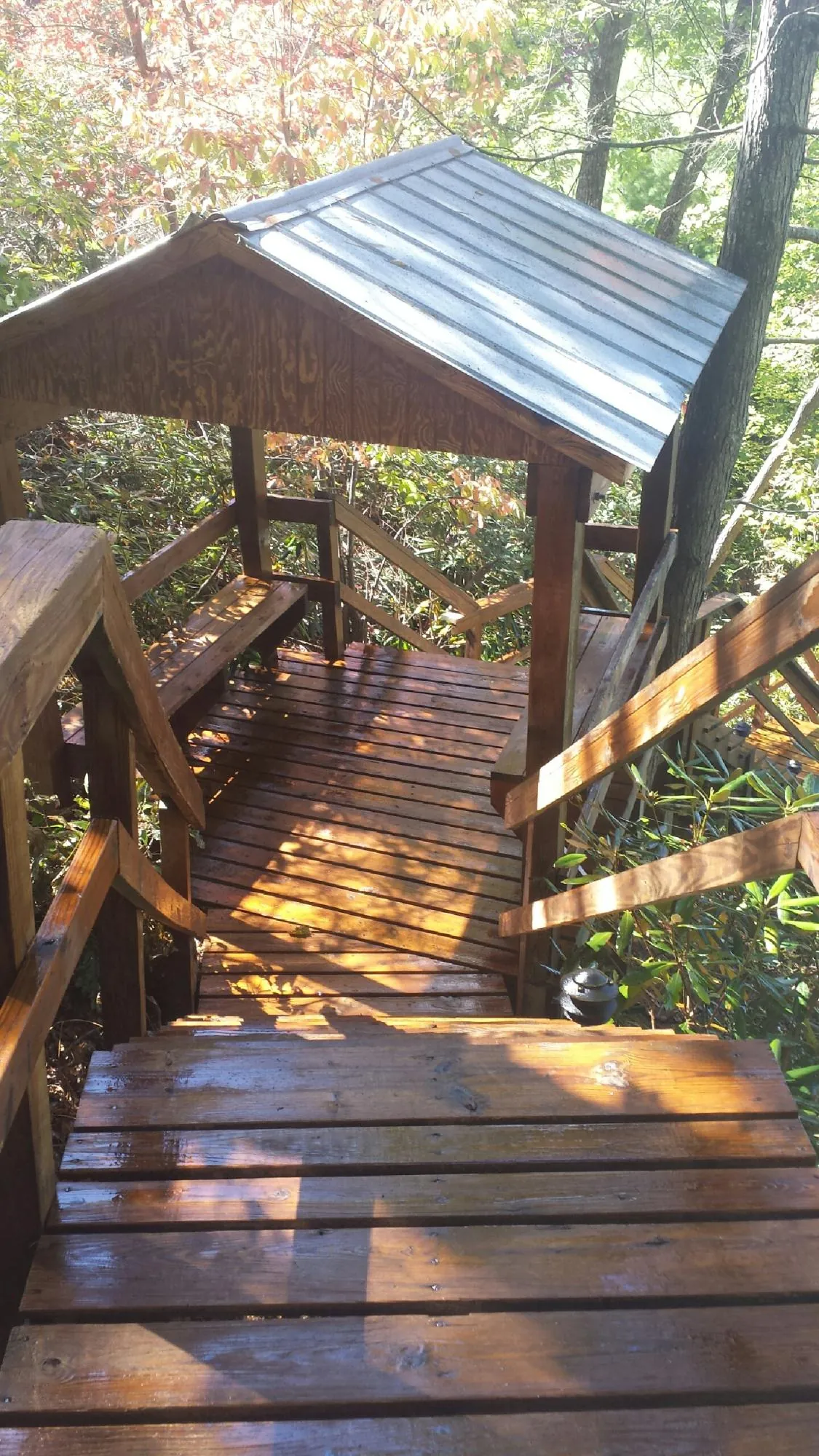 Freshly stained wood walkway and covered shelter with a metal roof in Red Rock